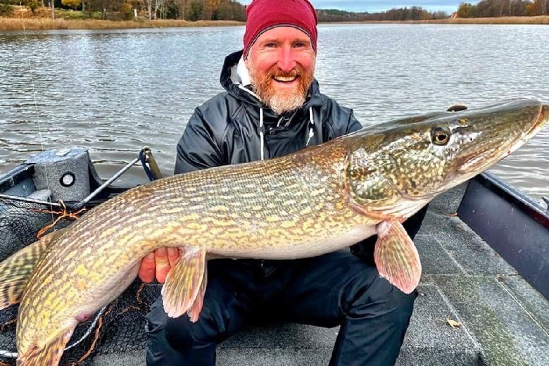 Angler holding a pike caught at Lake Sibbo